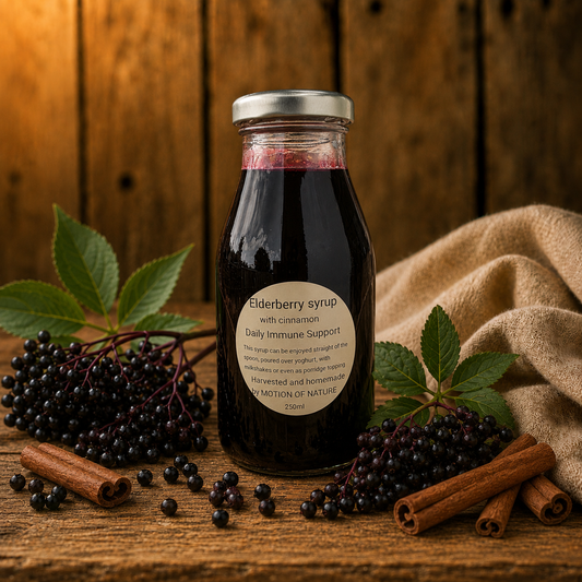 Bottle of elderberry syrup with ingredients on a wooden surface