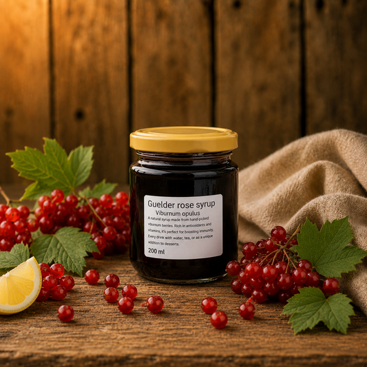 Jar of Guilder rose syrup with red currants and a lemon wedge on a wooden surface.