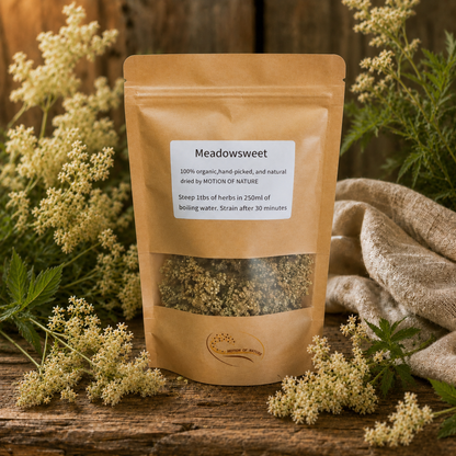 Meadowsweet packaging with dried herbs on a wooden surface surrounded by meadowsweet flowers.
