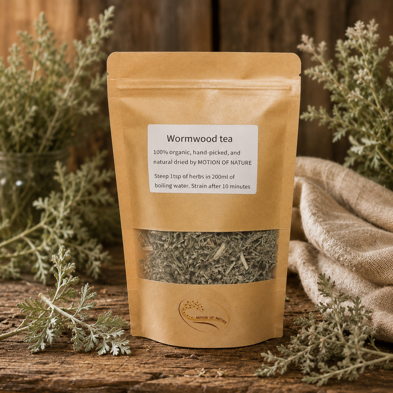 Wormwood tea package on a wooden surface with herbs around